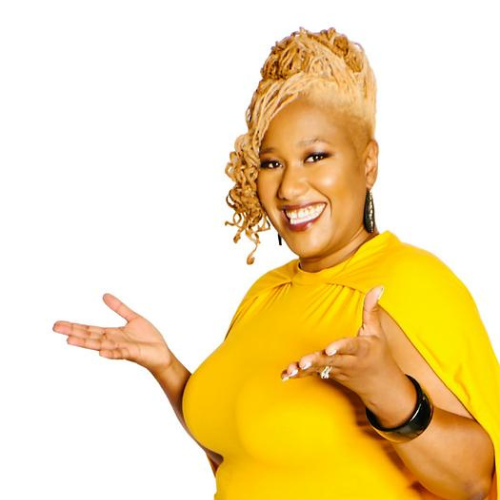 a Black woman looking at the camera with light hair piled on her head, wearing a yellow dress and smiling